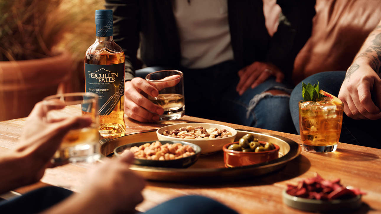 Powerscourt Distillery's Fercullen Falls Irish Whiskey lifestyle photo of people enjoying cocktails.