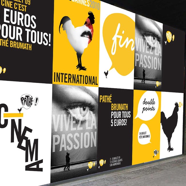 Pathe storefront with a billboard of posters.