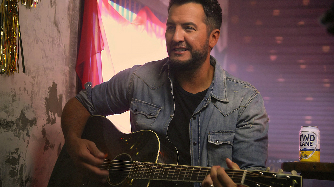 Two Lane beer can next to Luke Bryan playing guitar.